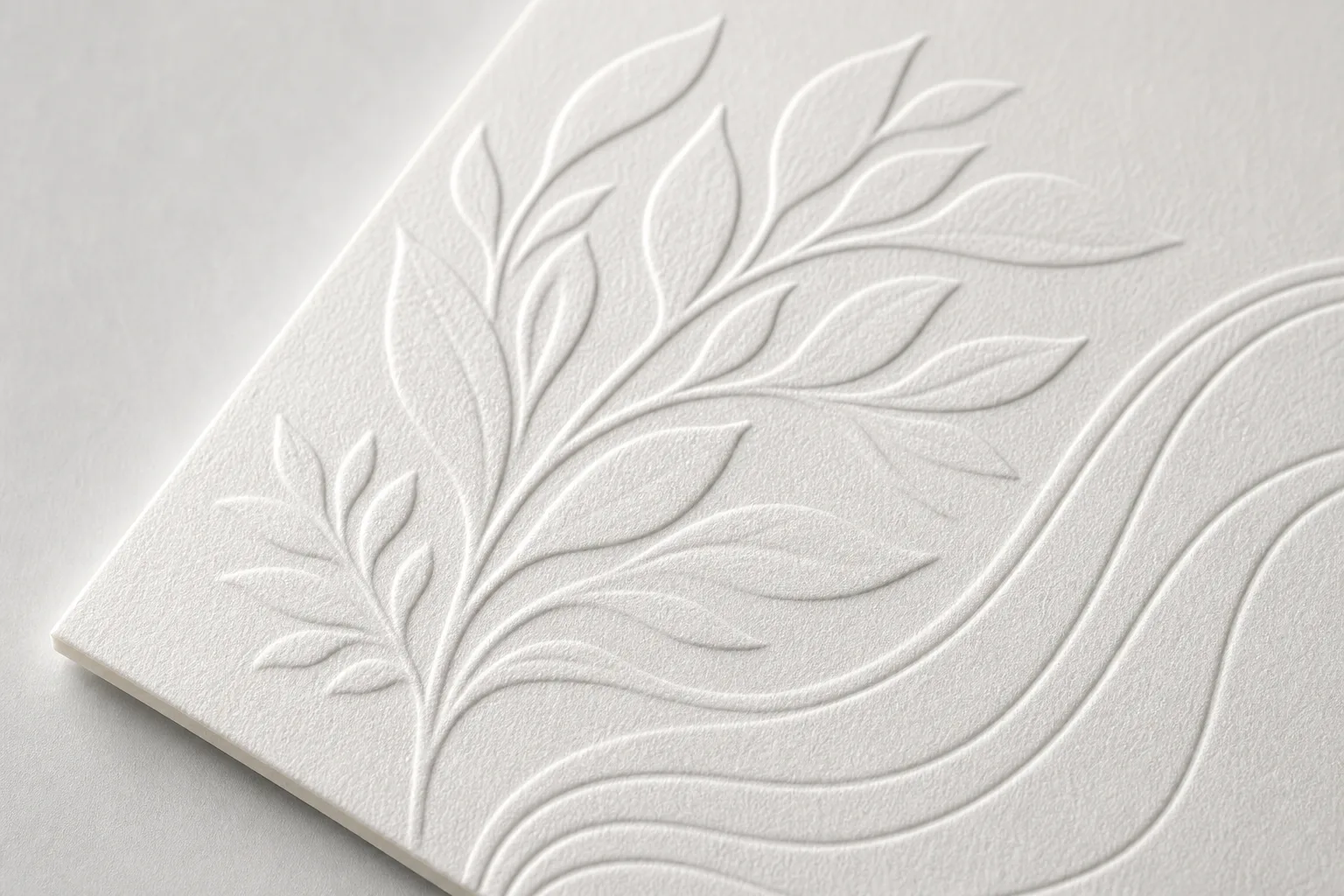 Raised embossed pattern on white luxury paperboard