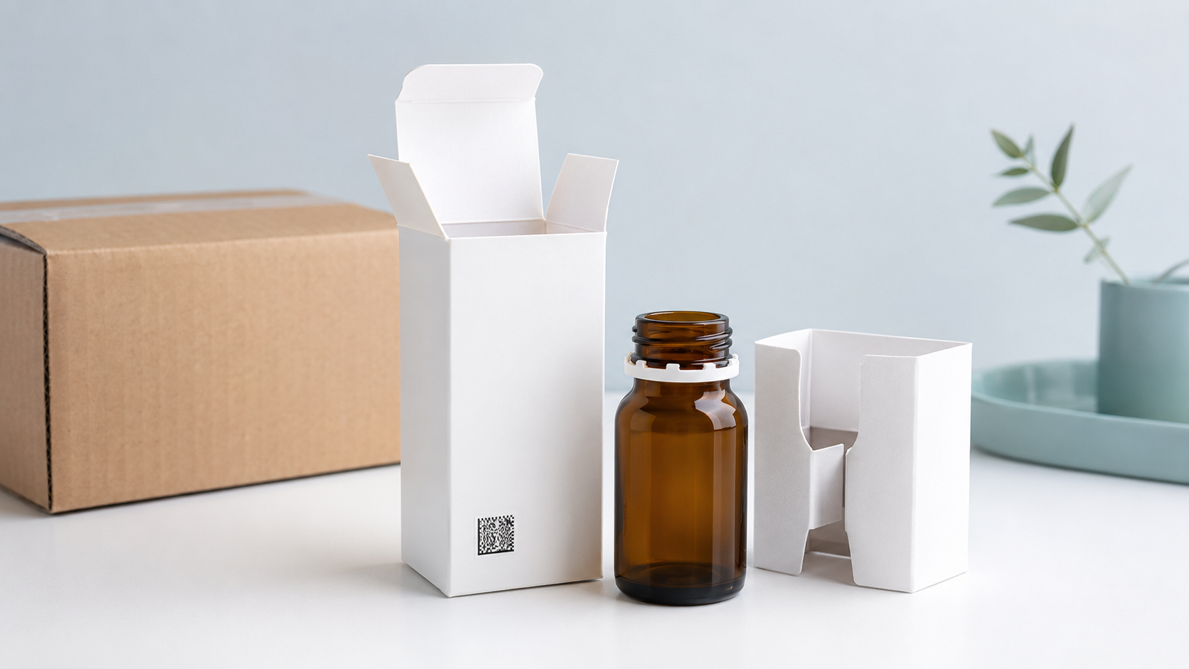 Unbranded pharmaceutical folding carton, amber bottle, paperboard insert, and corrugated shipping case arranged in a clinical studio